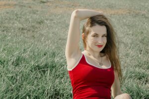 Woman smiling while sitting on grass